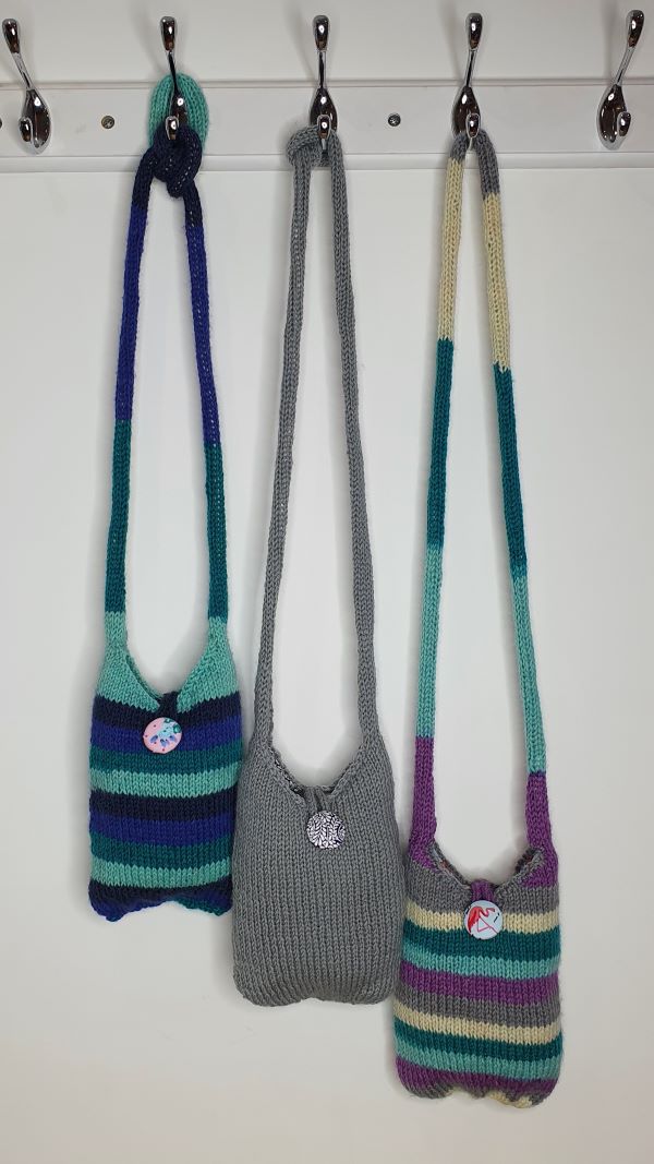 Small Bags with long handles hanging on hooks